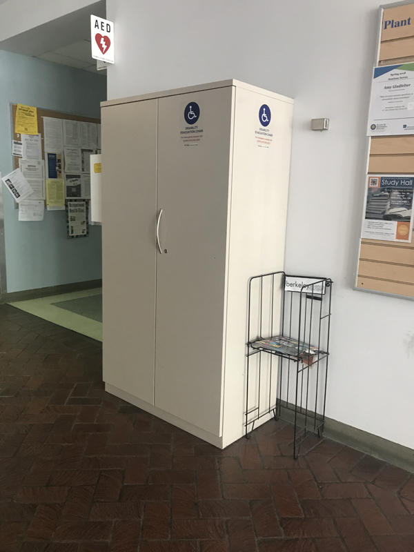 The evacuation chair for Koshland Hall, located near the front entrance on the right. The chair is located in an evacuation cabinet. 