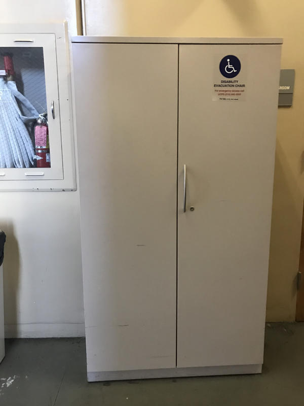 The evacuation chair for O'Brien Hall, located near the elevator. It is situated in an evacuation cabinet. 