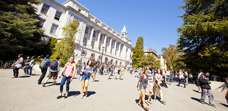 Exterior of Wheeler Hall, with a crowd of students gathered in front.