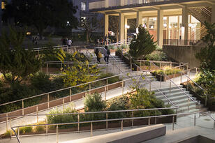 View of the stairs and ramps leading up to Sproul Plaza at night.