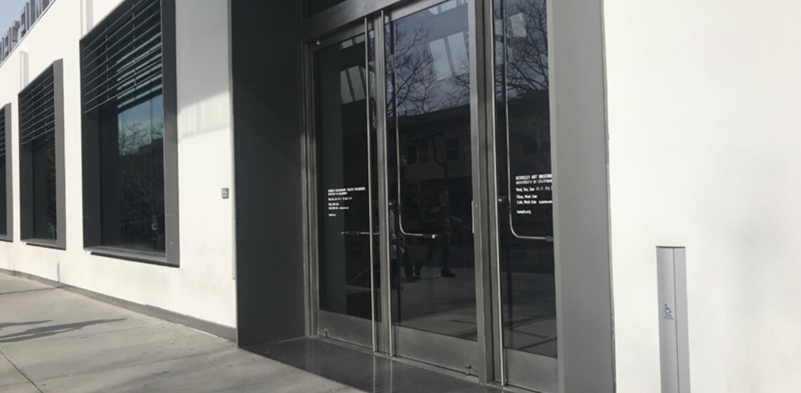 The southside entrance to BAMPFA. To the right of the entrance is an automatic door opener.