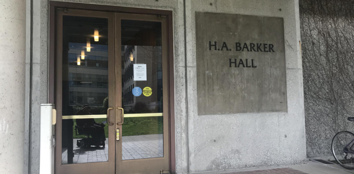 The accessible entrance to Barker Hall, facing south. To the left of the entrance is an automatic door opener.