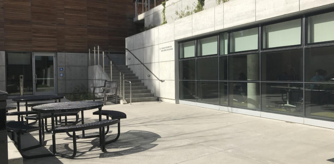 The south side of Blum Hall. To the right of the building's entrance is a staircase leading to the Blum Center for Economics.