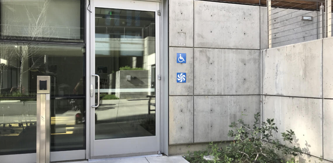 The accessible entrance to Blum Hall, facing east. To the left of the double doors is an automatic door opener.