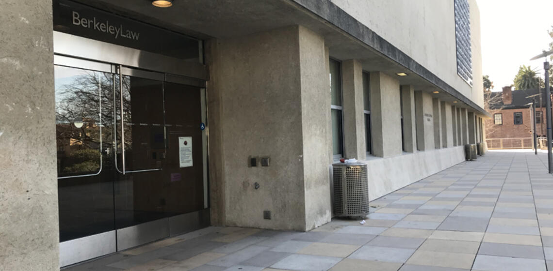 The accessible entrance to Berkeley law, facing west. There is an automatic door opener to the right of the entrance.