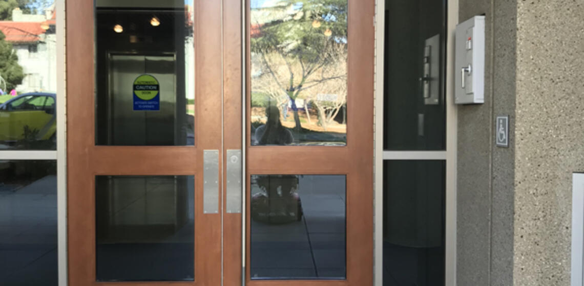 The main entrance to Campbell Hall, facing north. To the right of the etrance is an automatic door opener.