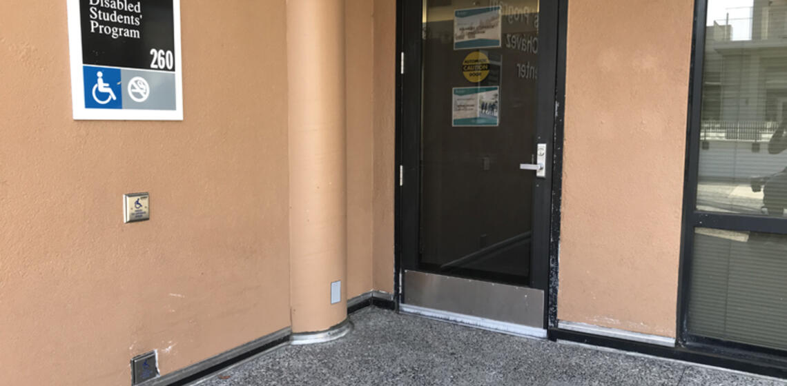 The main entrance to DSP, facing south. To the left of the entrance is an automatic door opener.