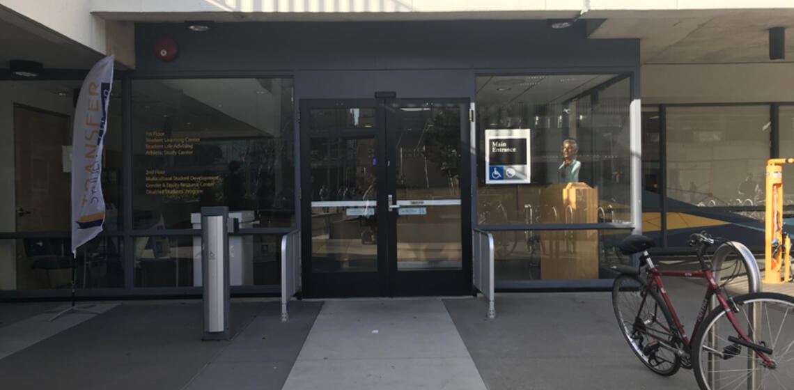 A south entrance to Cesar Chavez, located on Lower Sproul. To the left of the entrance is an automatic door opener.