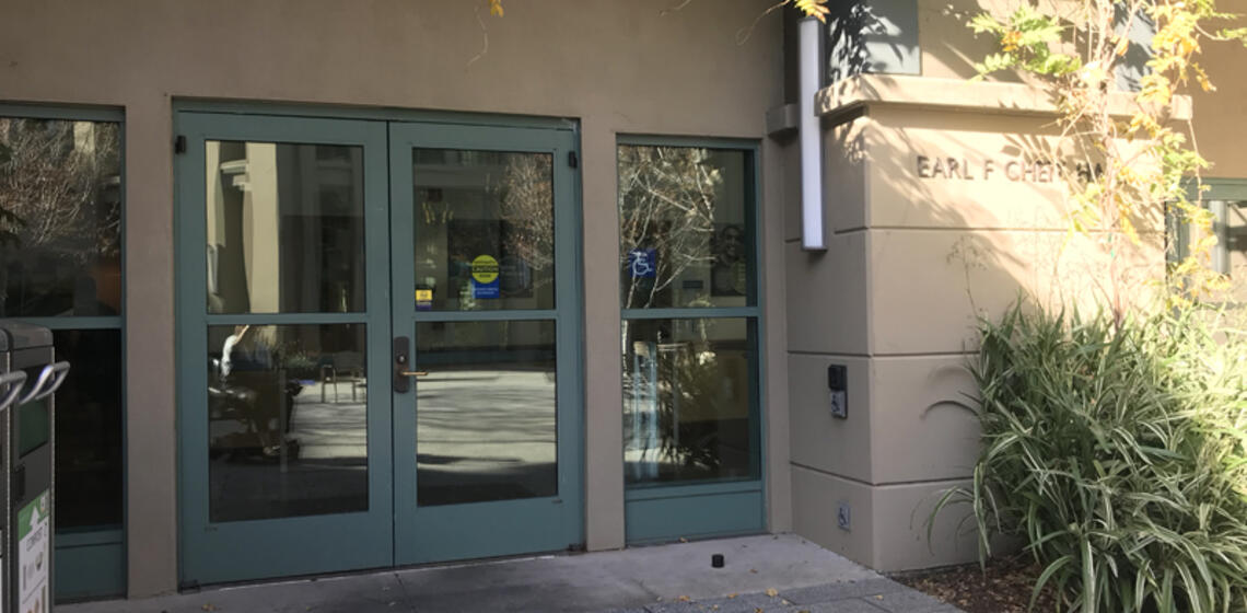 The accessible entrance to Cheit Hall, facing east. To the right of the entrance is an automatic door opener.