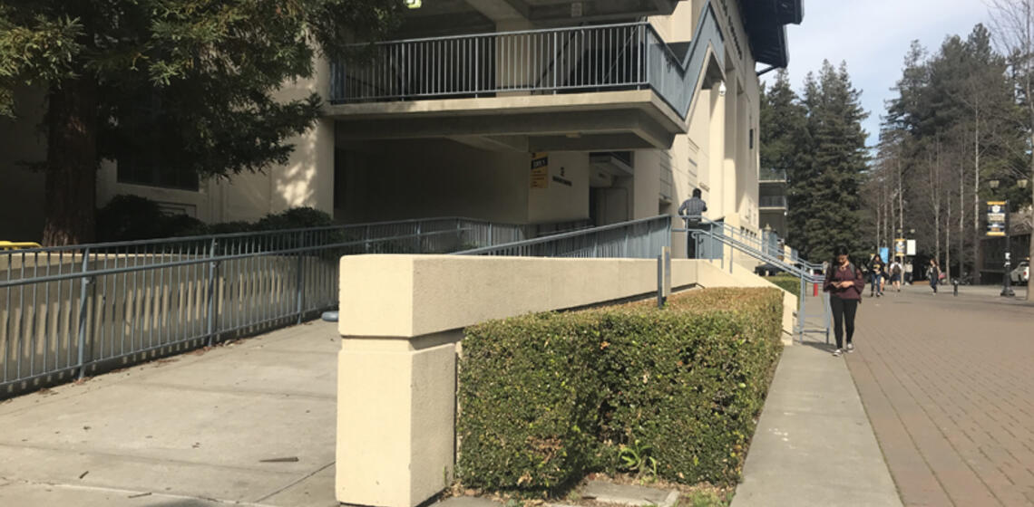 The accessible entrance to Haas Pavilion, which is a ramp located to the left of the building.