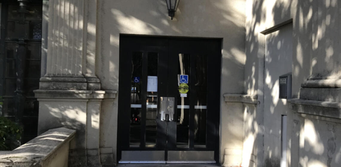 The accessible entrance to Hearst Gym, facing east. To the right of the doors is an automatic door opener.