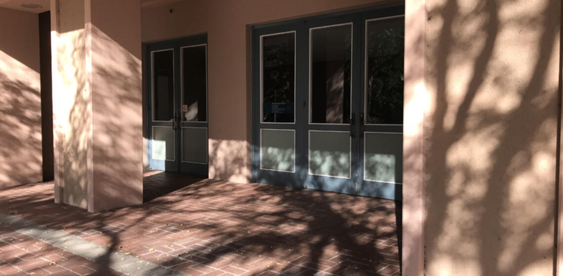 The main entrance to Hertz Hall, facing south. At the main entrance, there are three sets of manual doors.