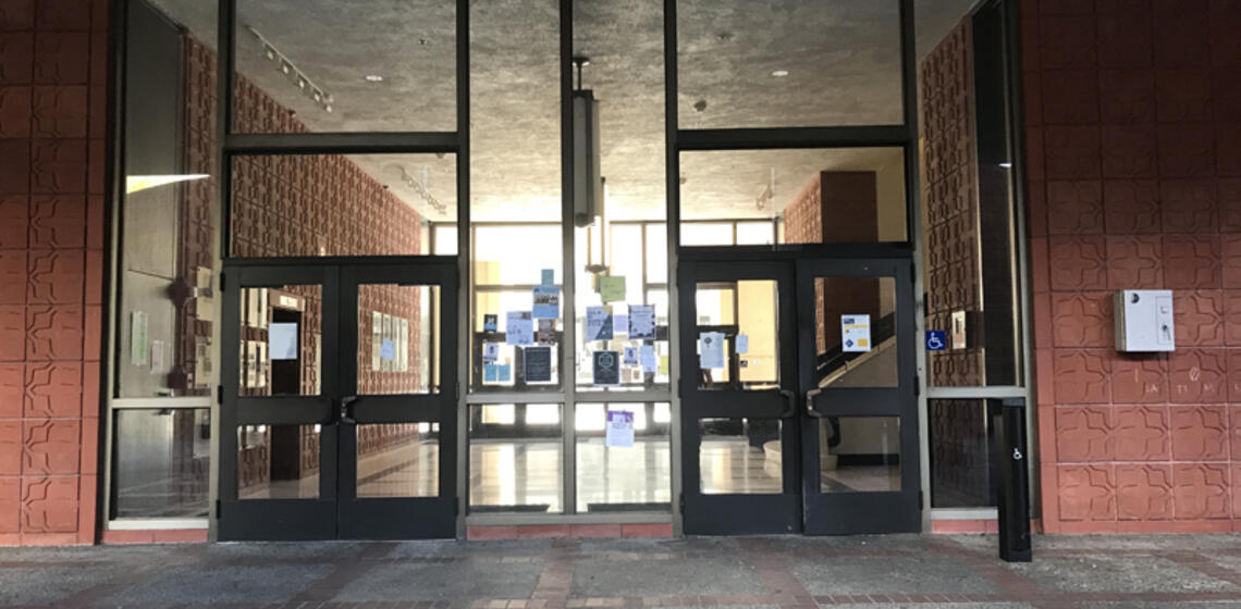 The north entrance to Latimer Hall. The rightmost set of doors has an automatic door opener to the right.