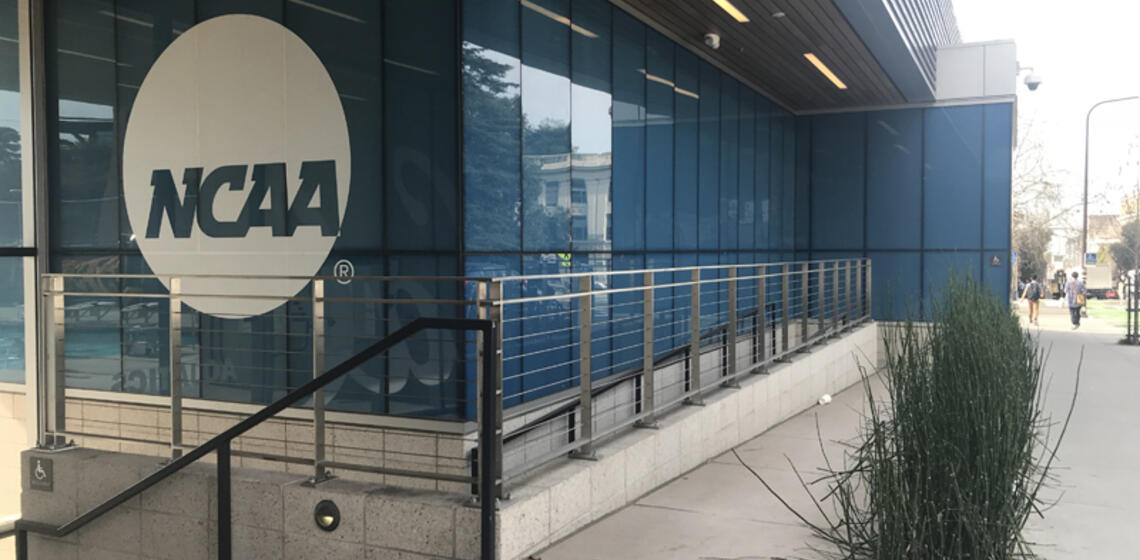 The accessible entrance to Legends Aquatic Center. It is a winding ramp leading down to the main doors.
