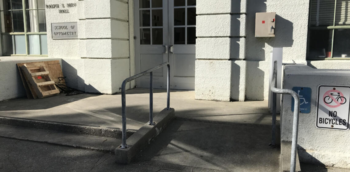 The accessible entrance to Minor Hall, facing east. There is a small ramp to the right of the stairs leading to the entrance.