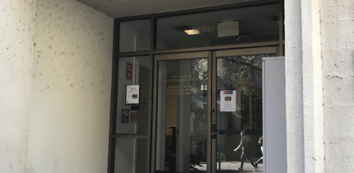 Accessible entrance to Philosophy Hall, facing east. To the right of the entrance is an automatic door opener and an evac chair.