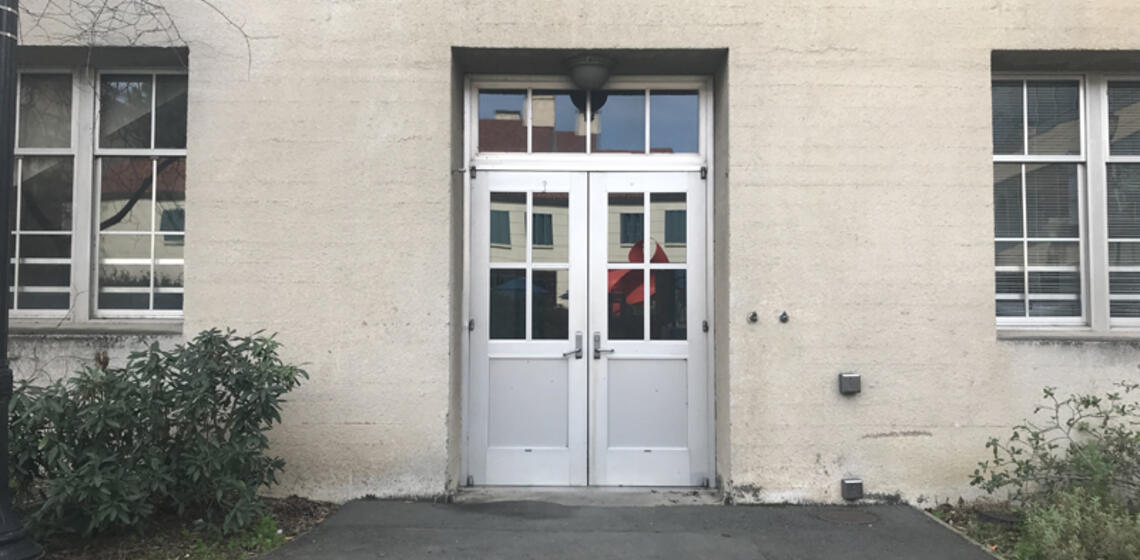 The accessible entrance to Mulford Hall, facing north. To the right of the doors is an automatic door opener.