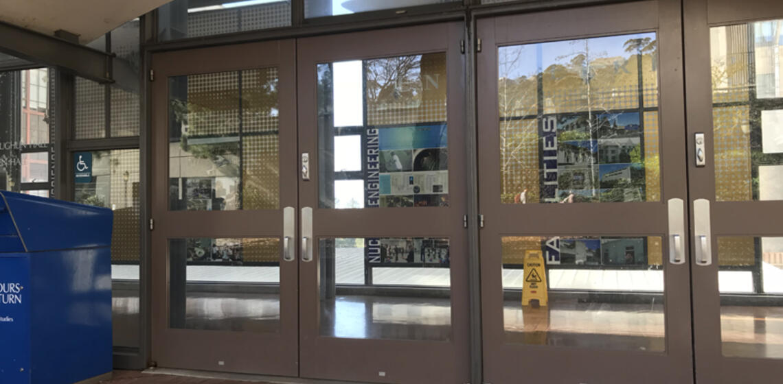 The main entrance to O'Brien Hall, facing east. To the left of the leftmost set of doors is an automatic door opener.