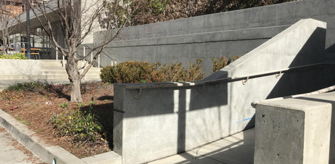 The accessible ramp to Sutardja Dai Hall, facing west. It is a winding ramp to the right of the entrance.