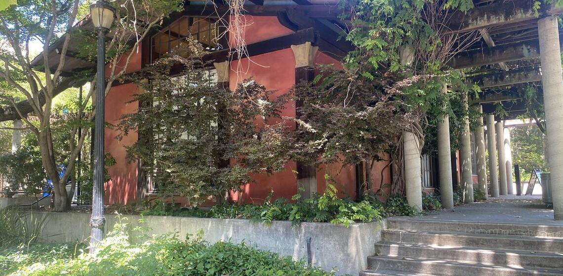 Steps from the west side of the building leads to the building main entrance.