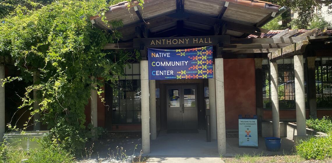 The south face of Anthony Hall, a quaint one-story building surrounded by trees.