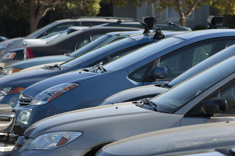 Close up of cars parked in a campus parking lot. 