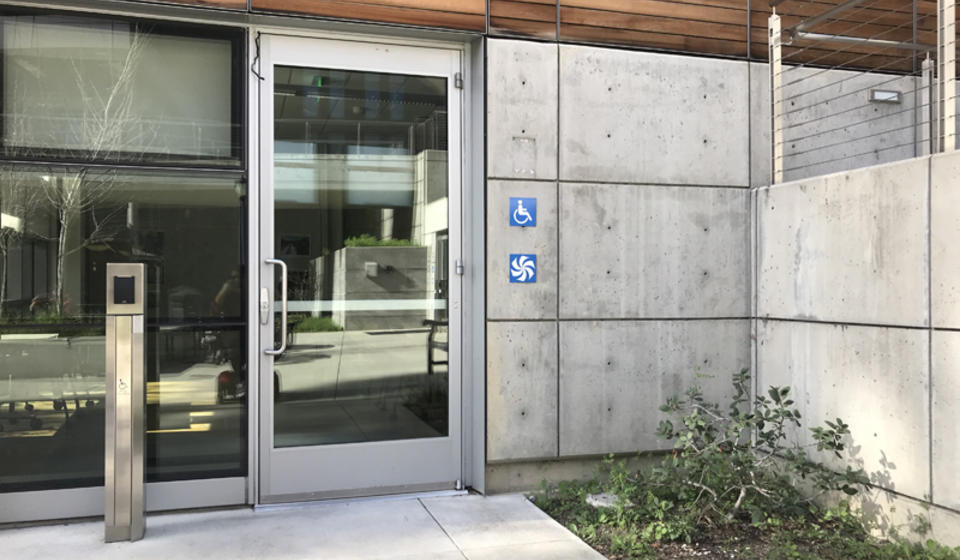 The accessible entrance to Blum Hall, facing east. To the left of the double doors is an automatic door opener.