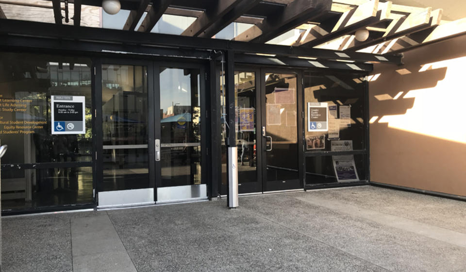 A south entrance to Cesar Chavez, located on Upper Sproul. To the right of the entrance is an automatic door opener.