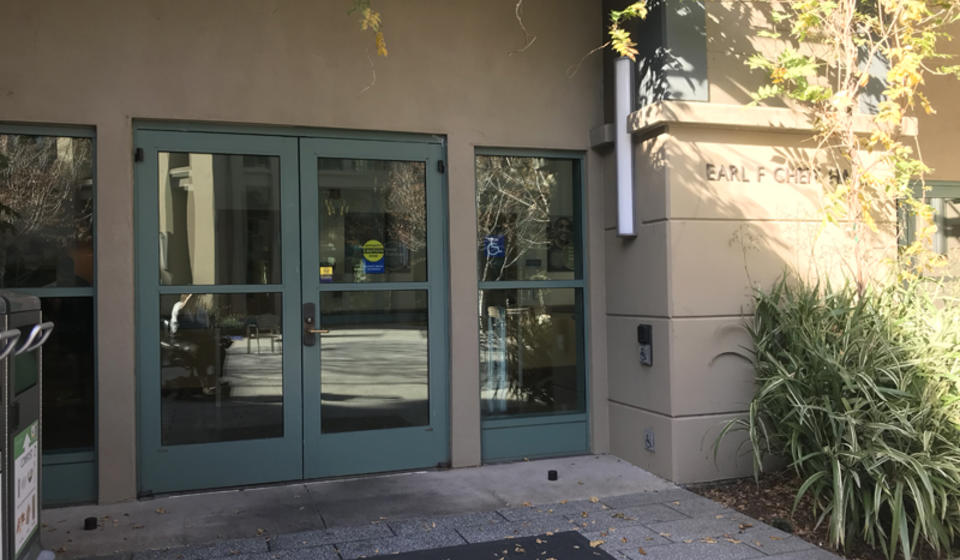 The accessible entrance to Cheit Hall, facing east. To the right of the entrance is an automatic door opener.