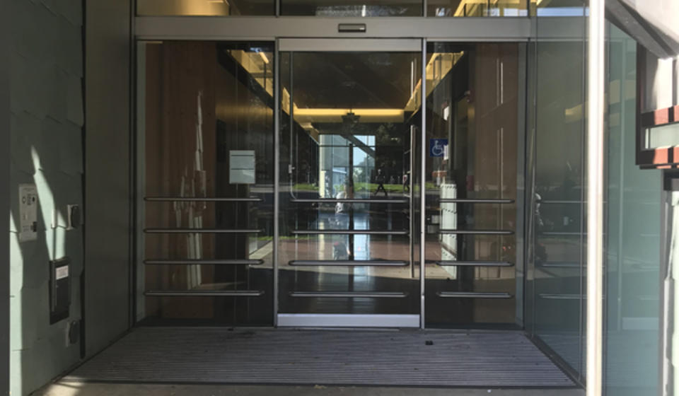 The main entrance to Hargrove Library, facing east. To the left of the entrance is an automatic door opener.