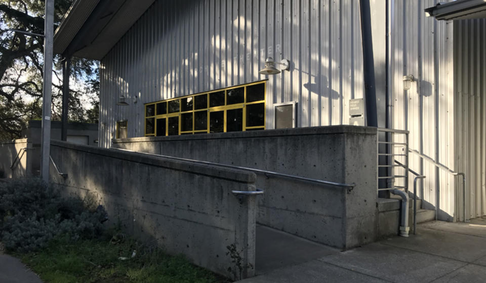 The accessible entrance to building A of Hearst Field Annex. There is a ramp to the right of the entrance's stairs.