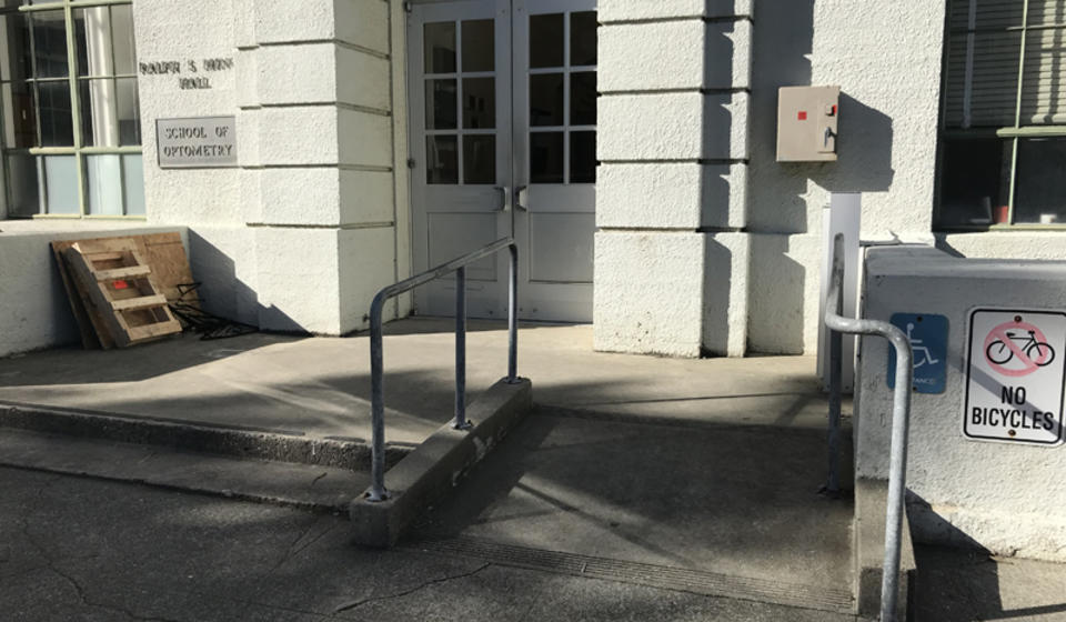 The accessible entrance to Minor Hall, facing east. There is a small ramp to the right of the stairs leading to the entrance.