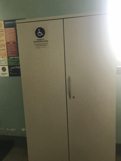 The evacuation chair for Mulford Hall, located near the northside entrance. It is situation in an evacuation cabinet. 
